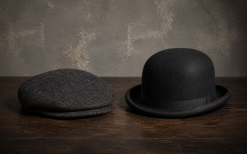Editorial still life comparing a low flat cap with a short forward peak and a domed Bowler hat with a curled all-around brim.