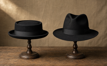 Side-by-side editorial comparison of a low flat pork pie crown and a creased pinched classic fedora silhouette.